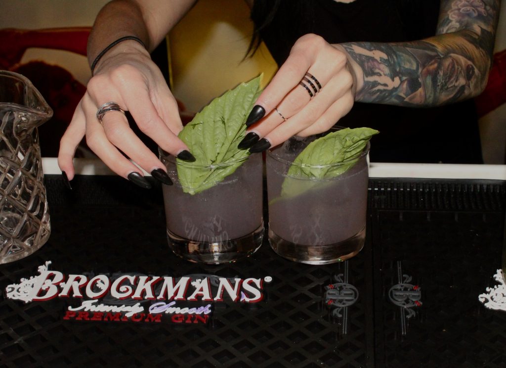 Nikki Diaz makes her Brockmans cocktail, the Black Widow, at Better Days in Miami