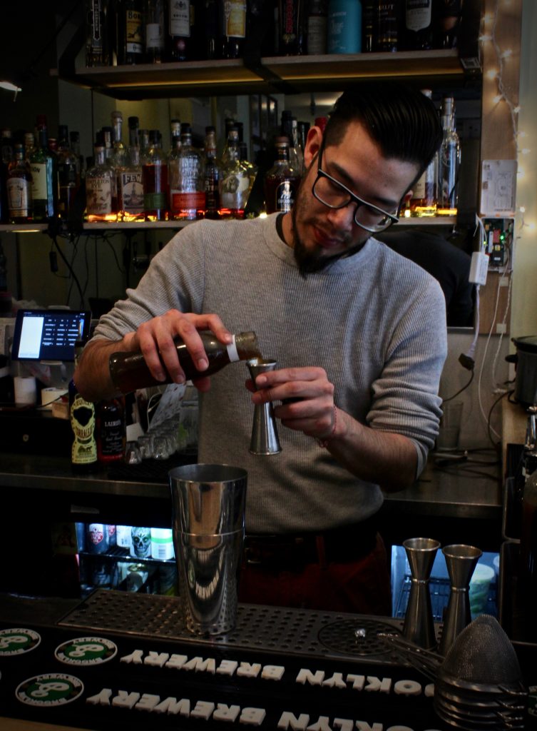Leo Cazares makes his Brockmans cocktail, Summer Angel, at Erv's on Beekman in Brooklyn, New York.