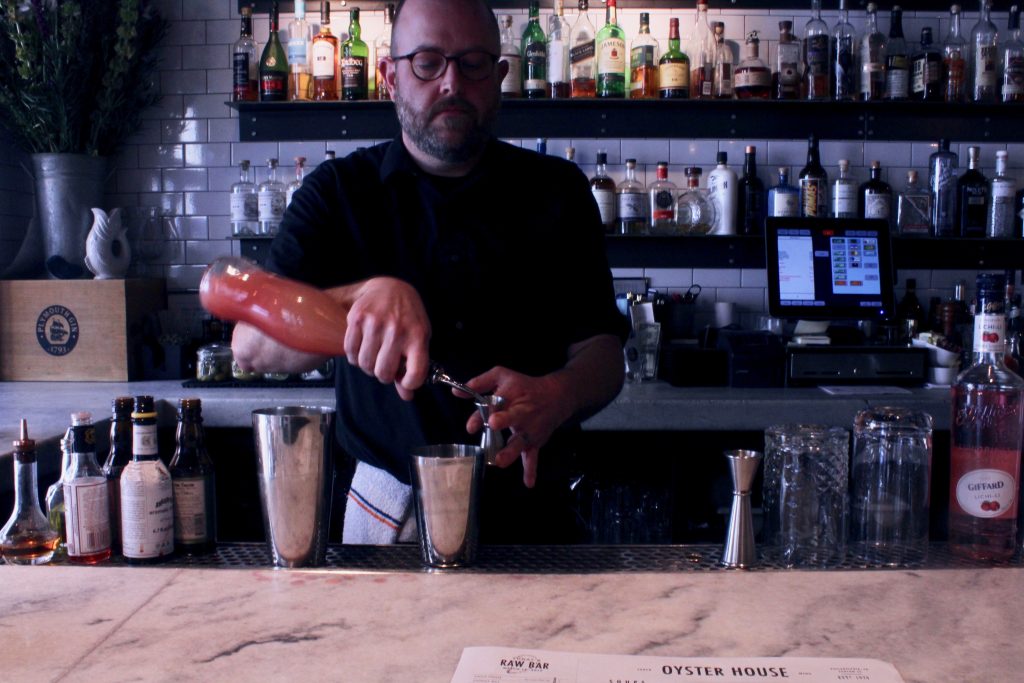 Colin Shearns makes his Brockmans cocktail, the Beach House, at the Oyster House in Philadelphia