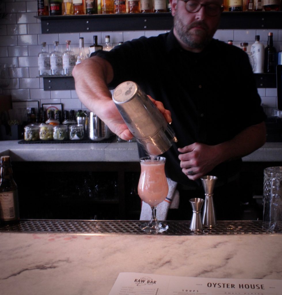 Colin Shearns makes his Brockmans cocktail, the Beach House, at the Oyster House in Philadelphia