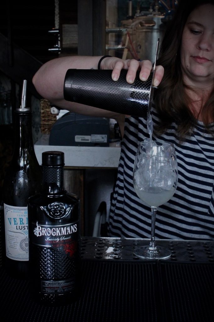 Michell Boyd makes her Brockmans cocktail, the "Blueberry Yum Yum" at Hampton and Hudson in Atlanta, Georgia.