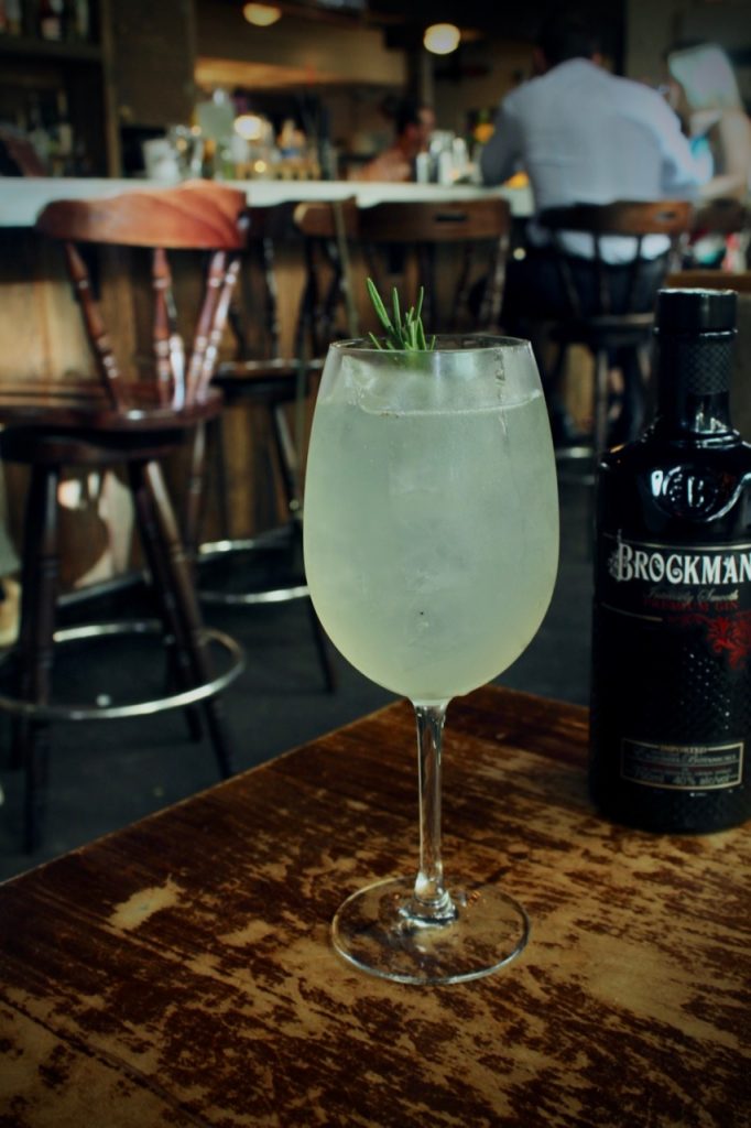 Michell Boyd makes her Brockmans cocktail, the "Blueberry Yum Yum" at Hampton and Hudson in Atlanta, Georgia.